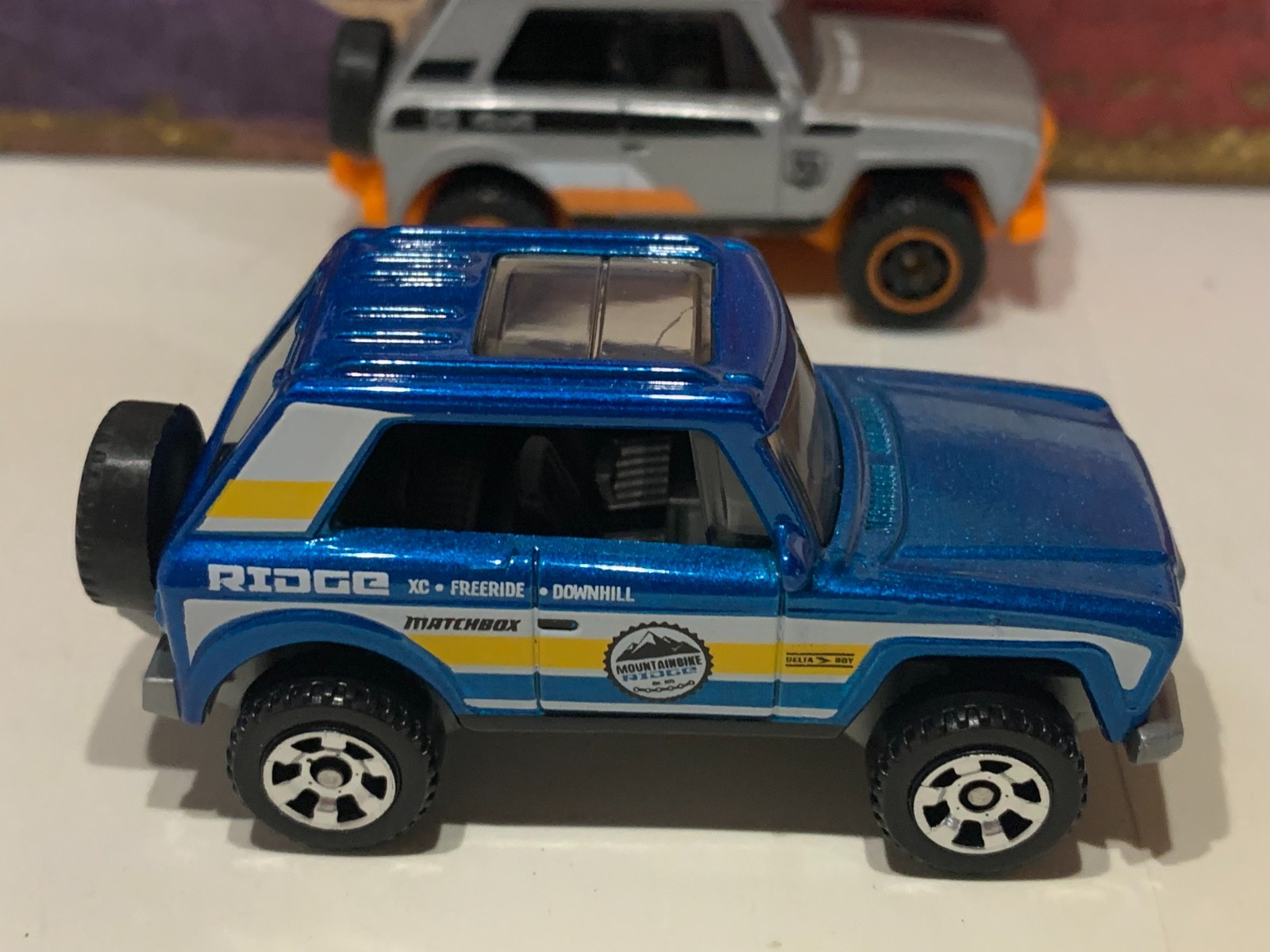 MATCHBOX MBX FIELD CAR X2. BLUE/YELLOW & SILVER /ORANGE MB 70 YEARS NICE