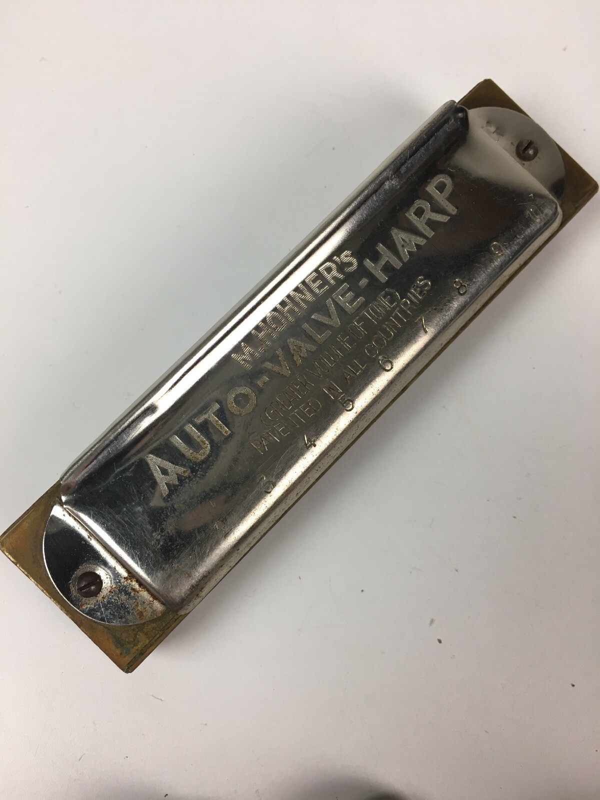 Mixed vintage lot – Hohner harmonica, Revlon, Eagle lock keys, Presbytarian coin